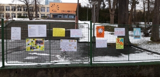 Vzkazy učitelů na plotě u školy  